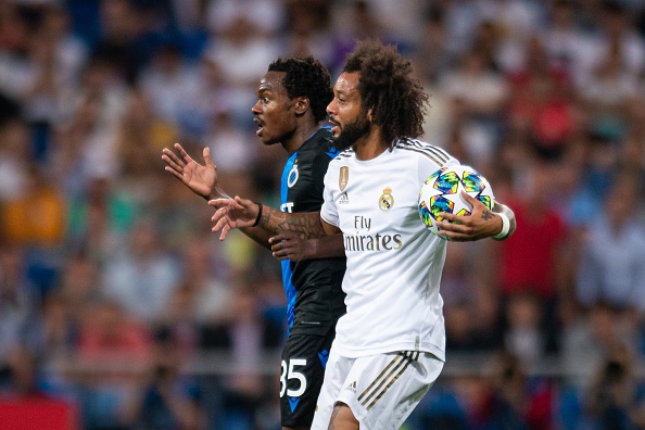 Percy Tau of Club Brugge and Marcelo of Real Madrid gesture during the UEFA Champions League group A match between Real Madrid and Club Brugge KV at Bernabeu on October 1, 2019 in Madrid, Spain. 