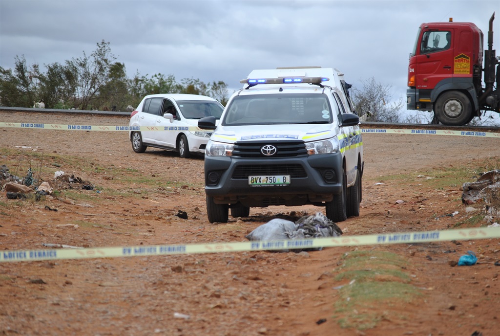 A police vehicle next to where one of the bodies was found in Khuma. Photo by Mohanoe Khiba