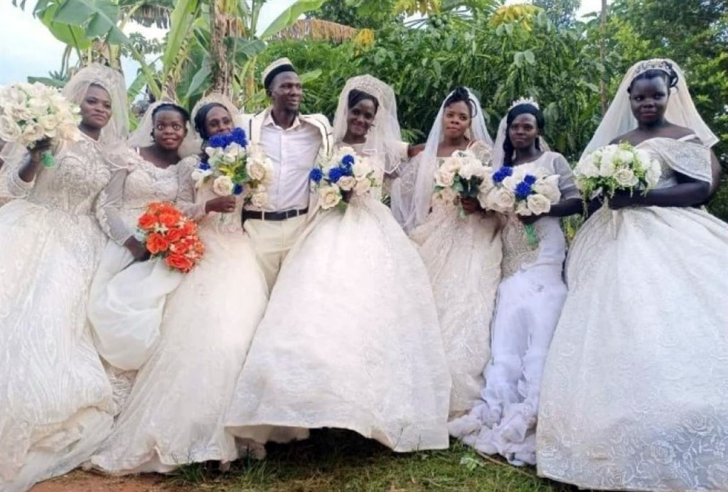  Habib Nsikonnene, 47, with his seven wives on their wedding day. 