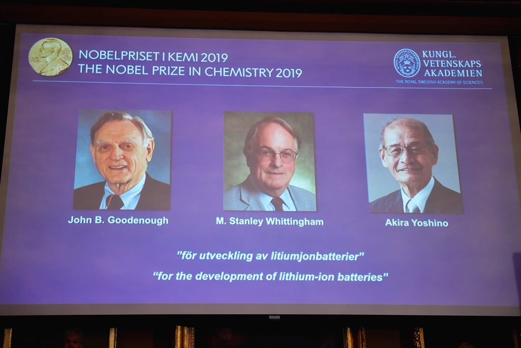 A screen displays the portraits of the laureates of the 2019 Nobel Prize in Chemistry (L-R) John Goodenough of US, Britain's Stanley Whittingham and Japan's Akira Yoshino during a press conference at the Royal Swedish Academy of Sciences in Stockholm, Sweden. (Naina Helen Jama, TT News Agency, AFP)