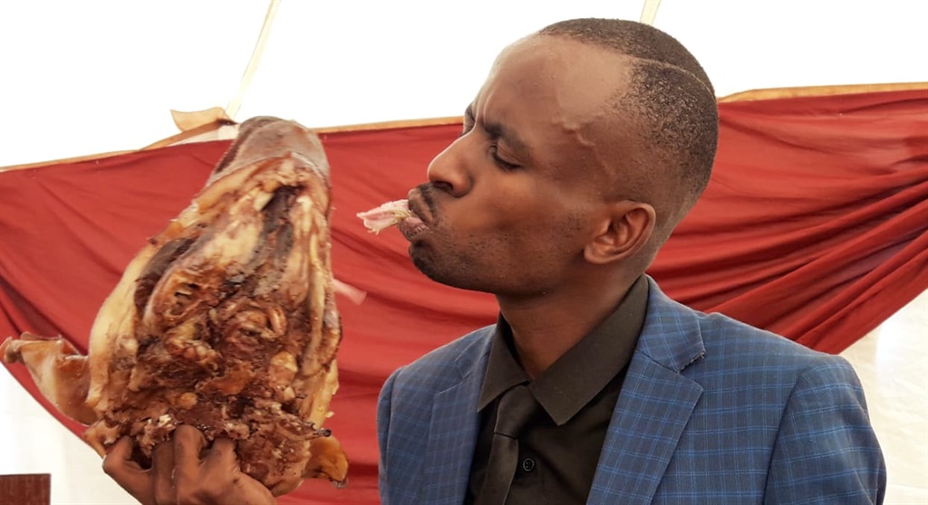 Prophet Rufus Phala showing off a pig skop in his church during a Holy Communion service on Sunday. Photo: Supplied.