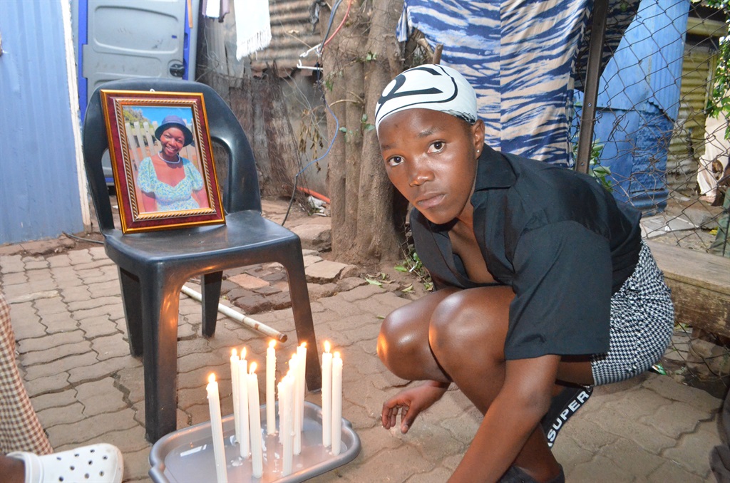 Louisa Petersen lights a candle to pay tribute to 