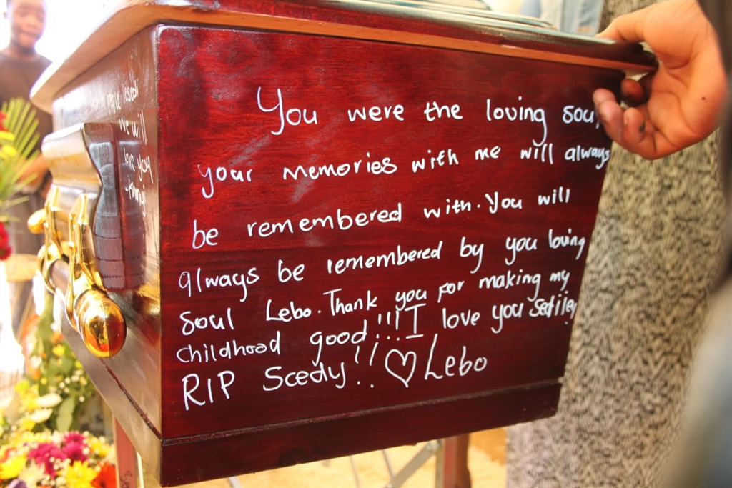 Lesedi Mbanguzi's classmates and friends wrote messages on his coffin. Photos by Phineas Khoza