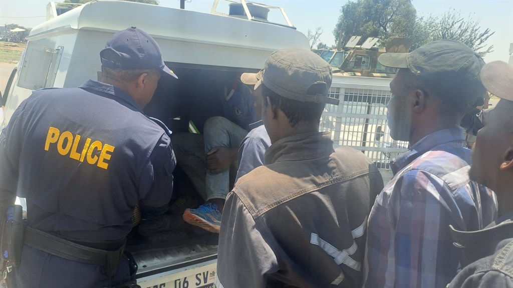 Police loading suspects into back of van