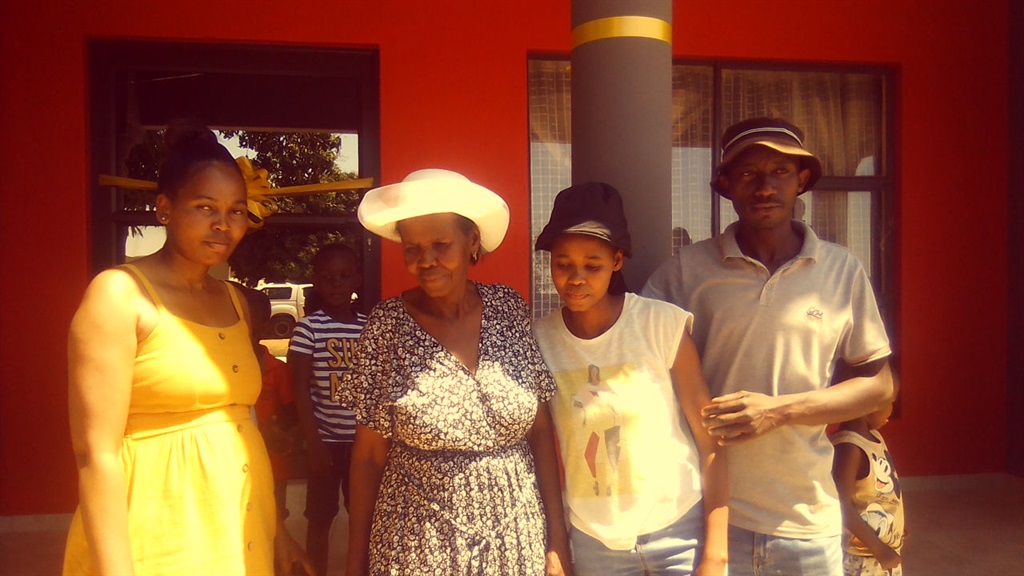 Nelly Skhosana (white hat) flanked by her kids, Gr