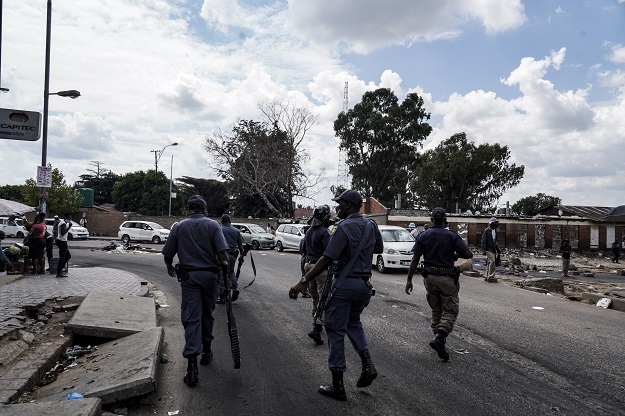 Police officers patrol Alexandra amid protests by Operation Dudula. Supporters are set to head to Durban on the weekend.