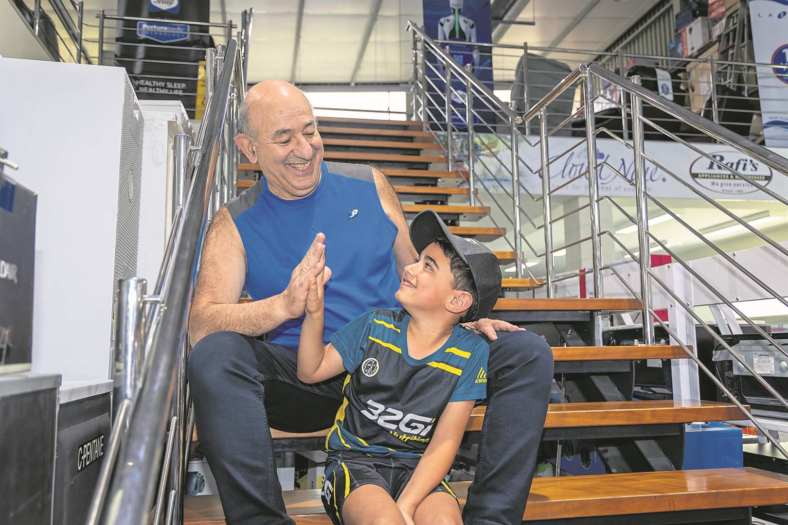 Ready to Run - Rafi Selvilya (left) of Rafi’s Appliances and Mattresses, with 32Gi club junior member, eight-year-old Tristan Leonard.                          