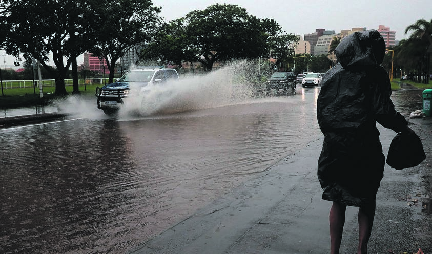 Nowhere to run, a pedestrian tries to dodge a flooded street in Durban. Picture: Sandile Ndlovu/Sowetan