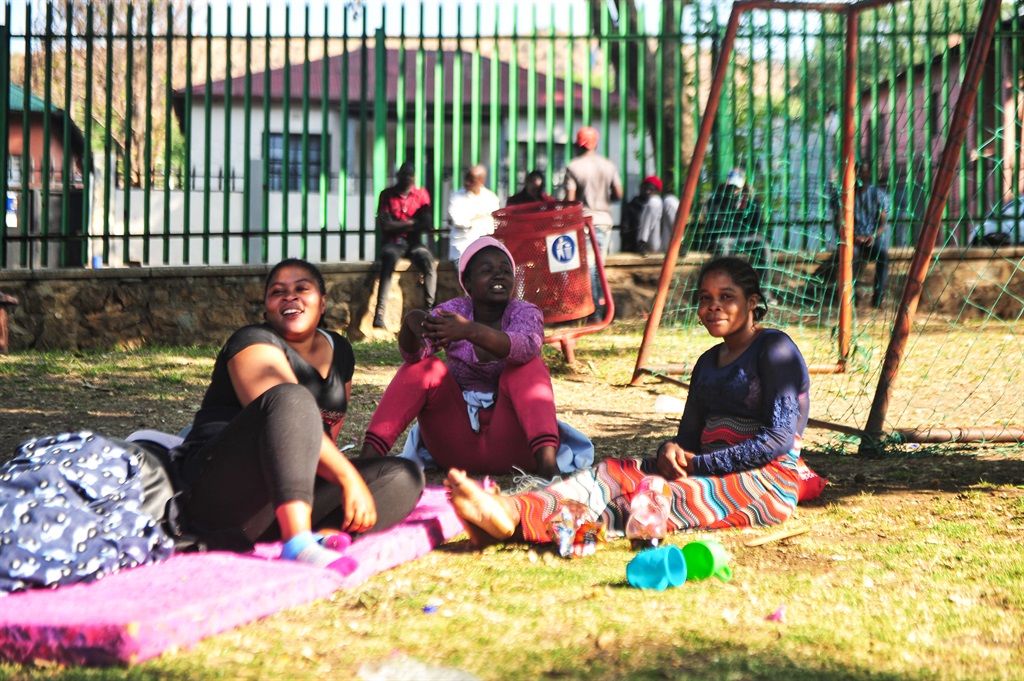 Women at the shelter, basking in the sun. Photo: Rosetta Msimango