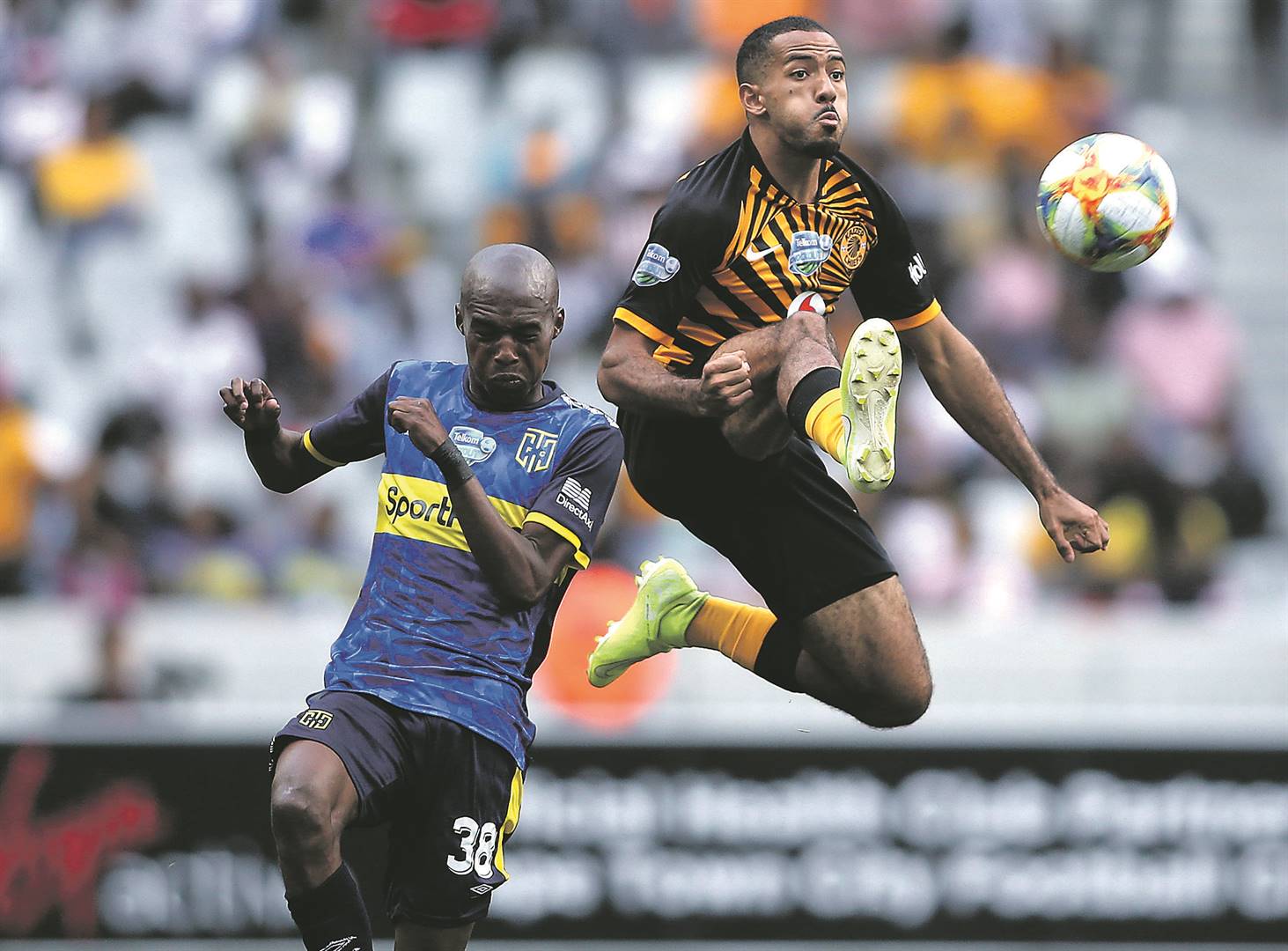 Reeve Frosler of Kaizer Chiefs wins the cross ball from Zukile Kewuti of Cape Town City during the Telkom Knockout clash at the Cape Town Stadium yesterday. Picture: Shaun Roy / Gallo Images