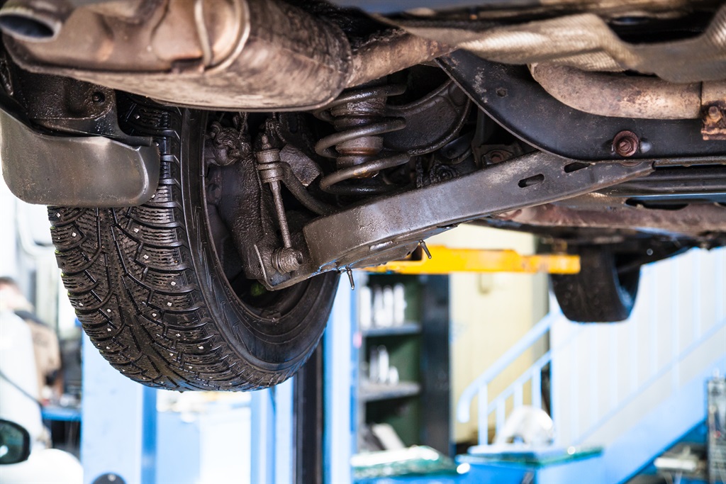 Check for leakages from a car's shock absorbers. T