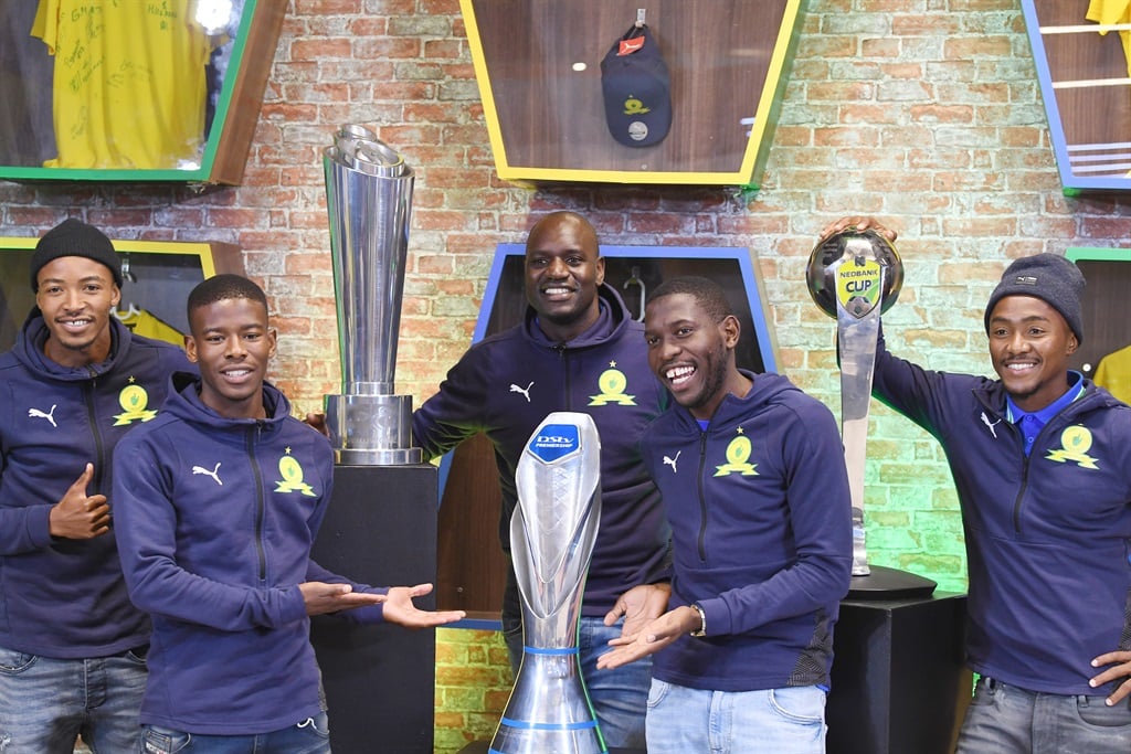 PRETORIA, SOUTH AFRICA - MAY 31:  Mamelodi Sundowns players Aubrey Modiba, , Denis Onyago,Thapelo Morena,Neo Maema and Lebohang Maboe pose with three trophies during the Mamelodi Sundowns trophy appreciation day at Mamelodi Mall on May 31, 2022 in Pretoria, South Africa. (Photo by Lefty Shivambu/Gallo Images)
