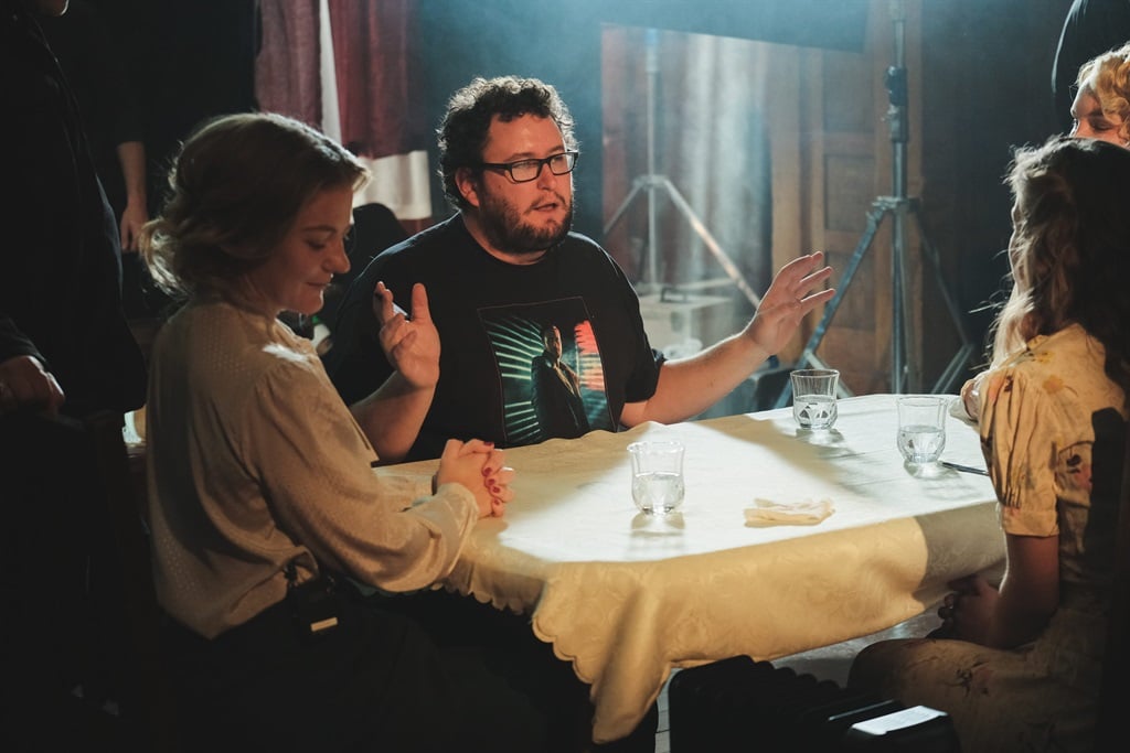 Writer and director Christopher Harvey chats on set with the actresses during the filming of Lunch with Hitler.