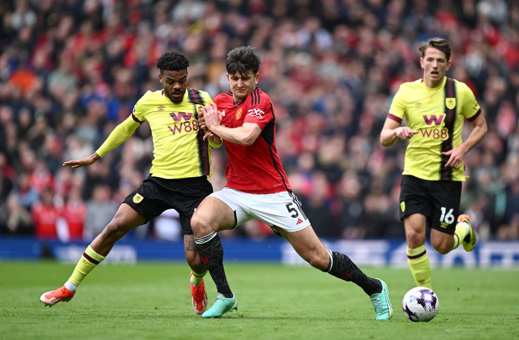 MANCHESTER, ENGLAND - APRIL 27: Lyle Foster of Burnley is challenged by Harry Maguire of Manchester United during the Premier League match between Manchester United and Burnley FC at Old Trafford on April 27, 2024 in Manchester, England. (Photo by Gareth Copley/Getty Images)