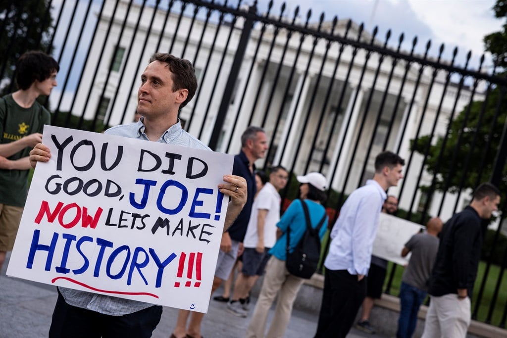 A man holds a sign showing his appreciation for US