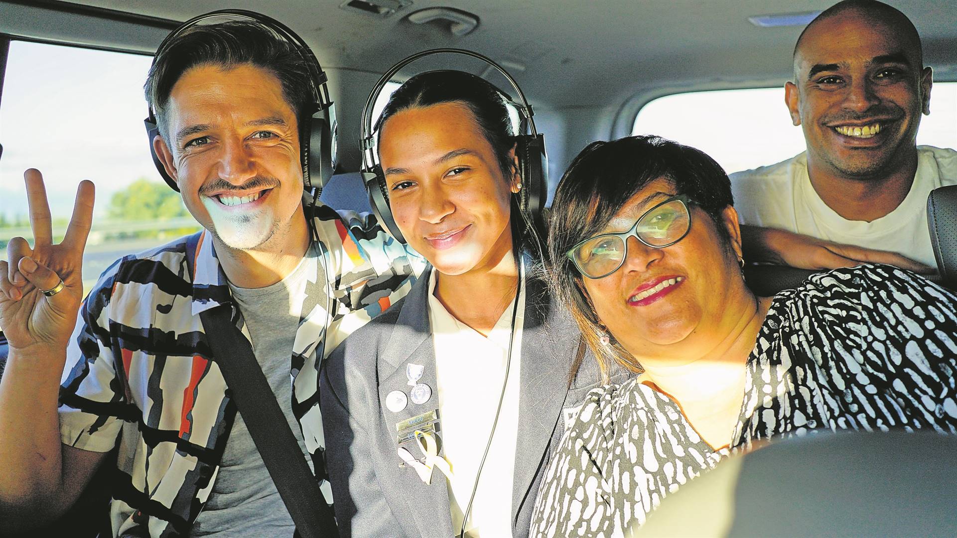 Amy February and her mom in the taxi with Danilo Acquisto (left) and Carl Lewis of Good Hope FM.
