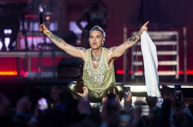 Robbie Williams - seen here performing recently on his world tour - is known for his larger-than-life personality. (PHOTO: Gallo Images/Getty Images)