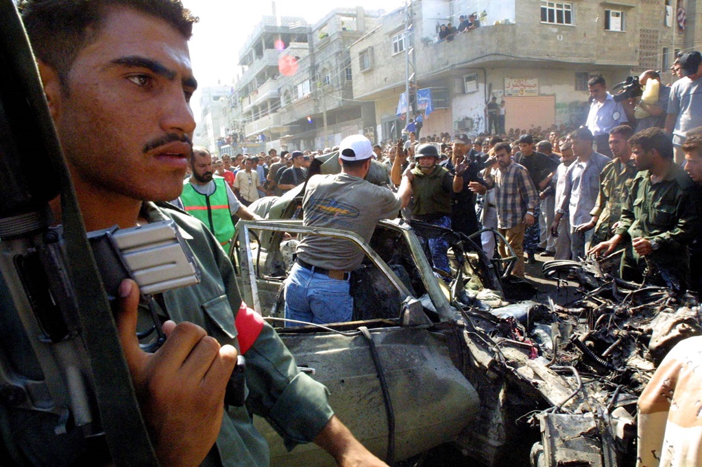 Car wreckage and a crowd