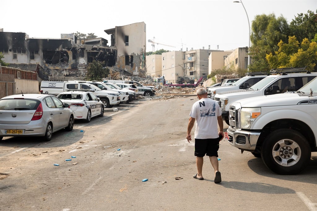 A man walks near a police station that was destroyed after a battle between Israeli troops and Hamas militants on 8 October, 2023 in Sderot, Israel. (Photo by Amir Levy/Getty Images)