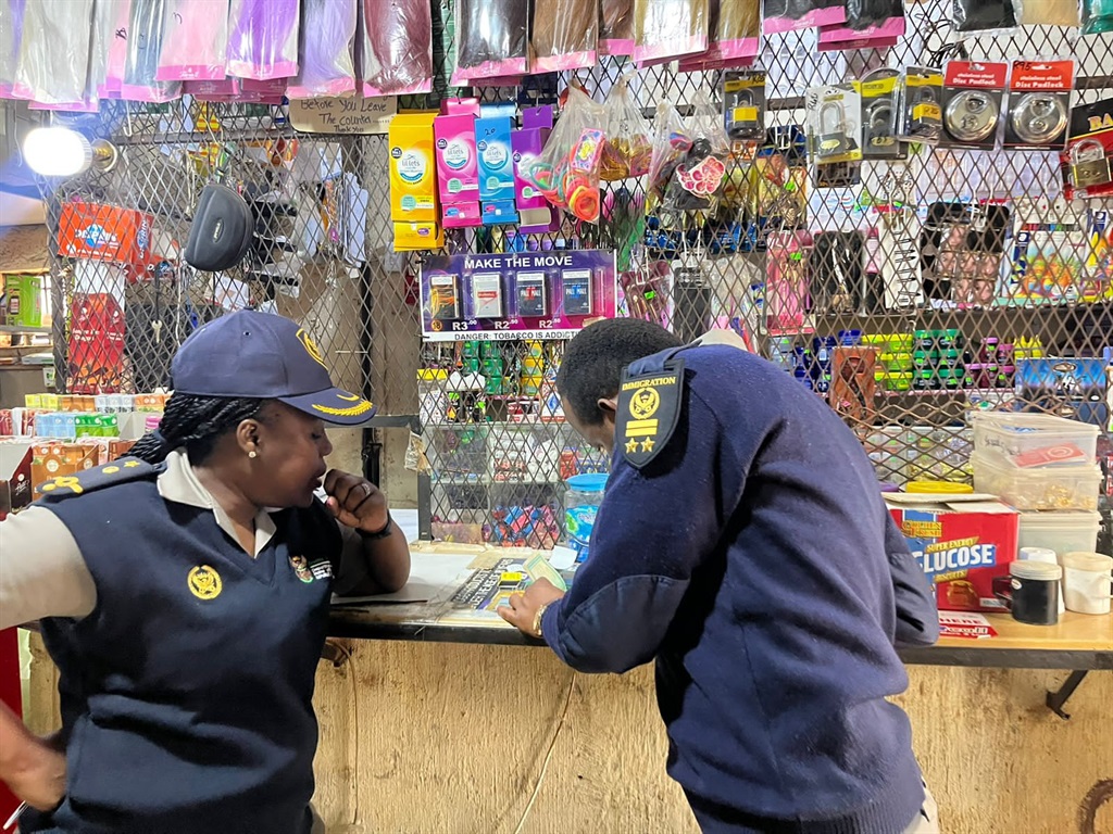 Municipality officials, Home Affairs officials and the police checking for expired food at foreign-owned shops. Photo Bongani Mthimunye
