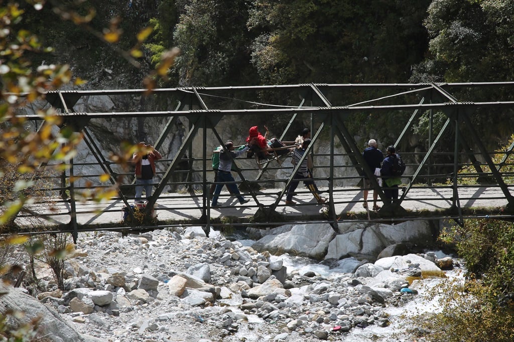 A woman devotee carried in a palanquin to Yamunotri temple Uttarkashi Uttarakhand, India. A tunnel is being dug close to the shrine to rescue the 41 trapped men.