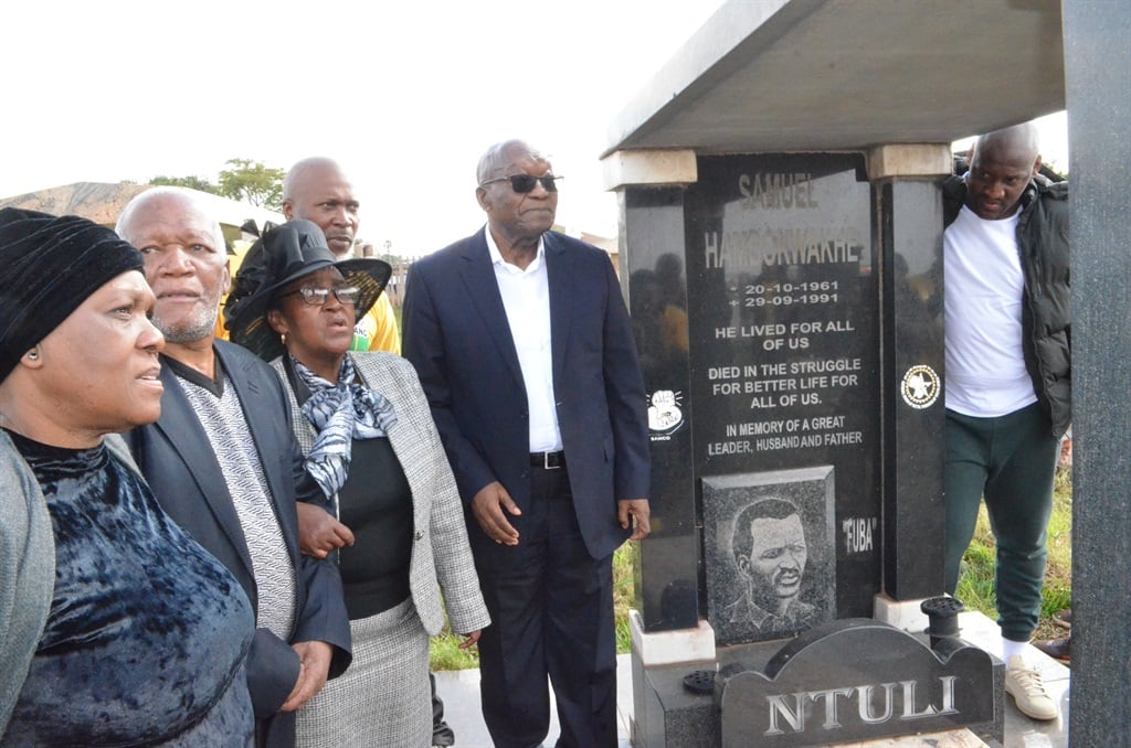 Former president Jacob Zuma with the Ntuli family at the grave of Sam Ntuli. Photo by Happy Mnguni