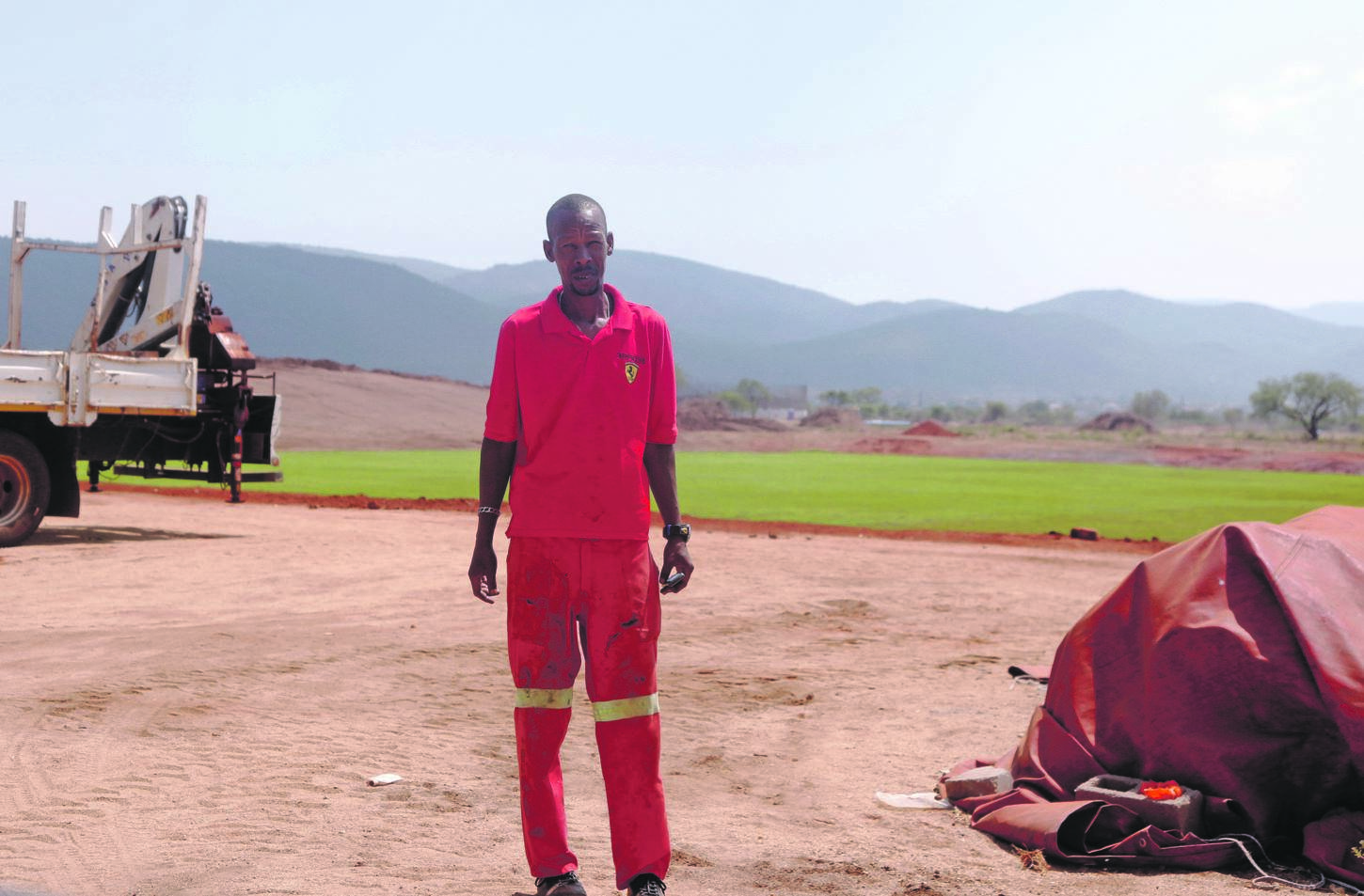 Tshepo Maphuta claims he wasn’t paid in full after being hired to lay grass on this soccer field.                                      Photo by Joshua Sebola