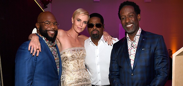Charlize Theron with Nathan Morris, Wanya Morris and Shawn Stockman of Boyz II Men (Photo: Getty Images)