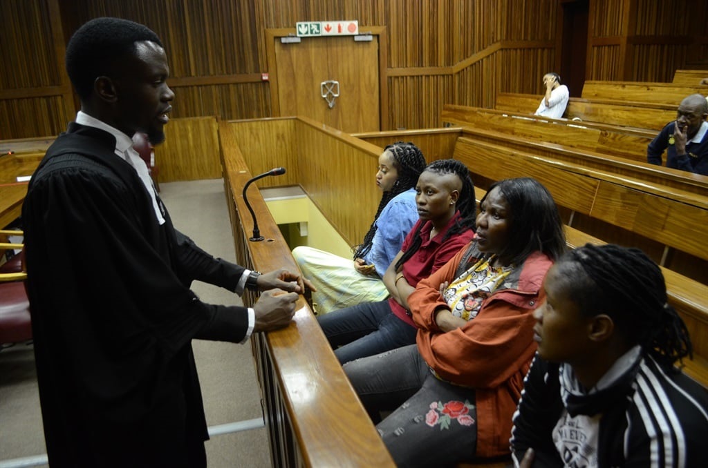 Advocate Pheane Lebea talking to the accused Margaret Koaile, Portia MmolaTshegofatso Moremane and Gontse Tlhoele. Photo by Happy Mnguni