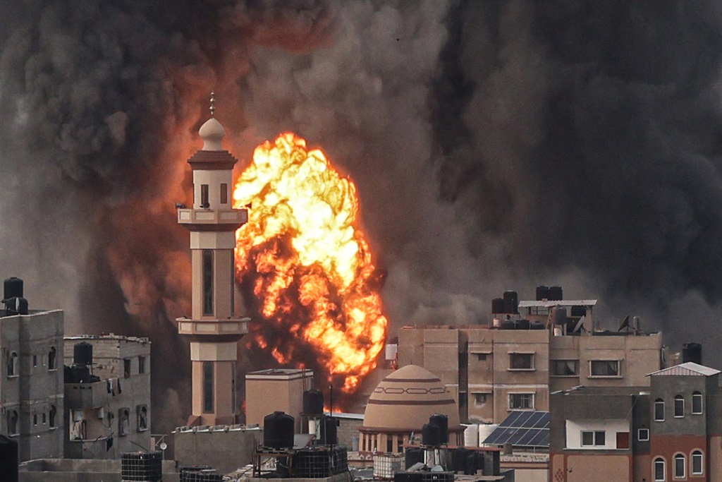 A fireball erupts after the Israeli strike over Rafah in the southern Gaza Strip on 20 December 2023.