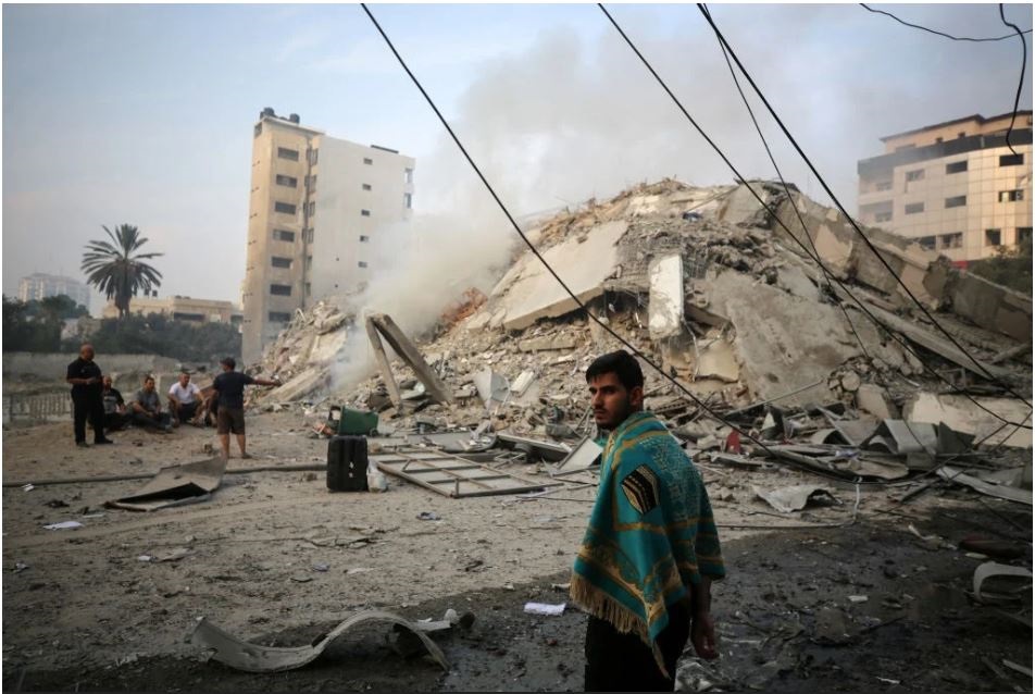 Residents next to a building destroyed as a result of Israeli-Palestine conflict. Photo from News24