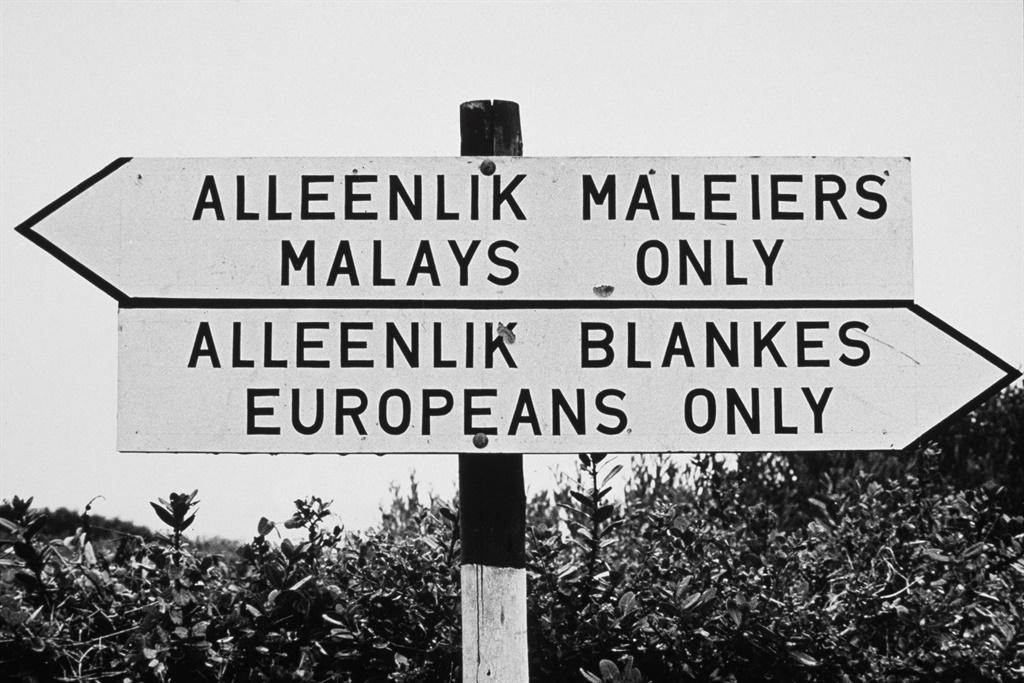 A sign on a beach in Port Elizabeth, South Africa, during the era of apartheid, circa 1960. It reads Alleenlik Maleiers, Malays Only and Alleenlik Blankes, Europeans Only. The beach is divided into seven sections for different races.  (Photo by Archive Photos/Getty Images)