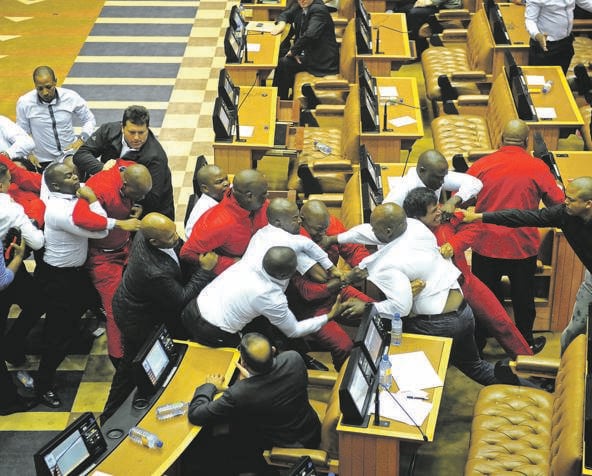 EFF members fight with Parliament security after they were ordered to be removed by the Speaker Baleka Mbete for continuously interrupting former president Jacob Zuma’s question and answer sessionPHOTO: lerato maduna
