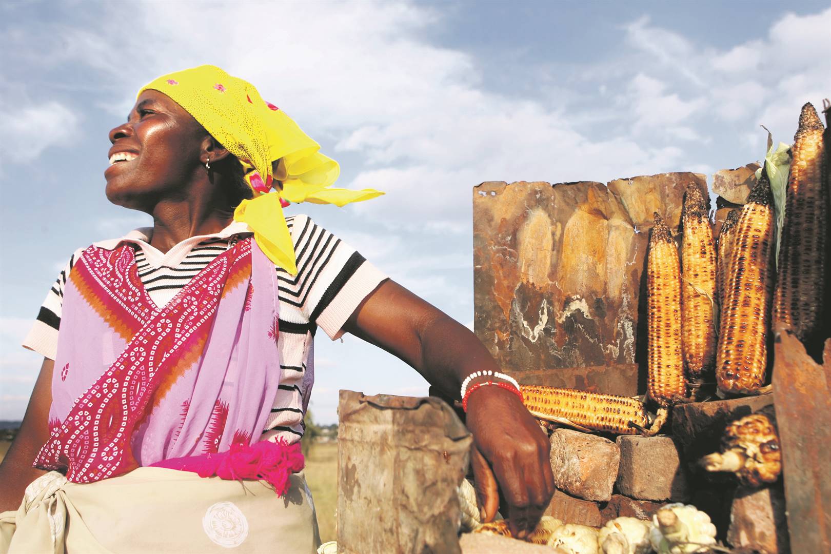 Tsakani Maluleka sells mealies to motorists on the side of the Golden Highway to Orange Farm. She relies on the business to educate her six kids, who are still at schoolPHOTO: Leon Sadiki