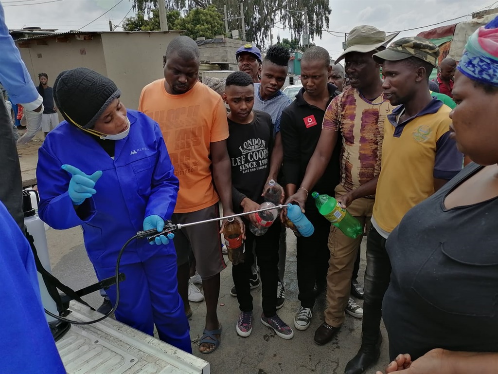 The Department of Economic Development, Agriculture and Environment blessed the people of Alex hostels with hand sanitisers. Photo: Trevor Kunune.