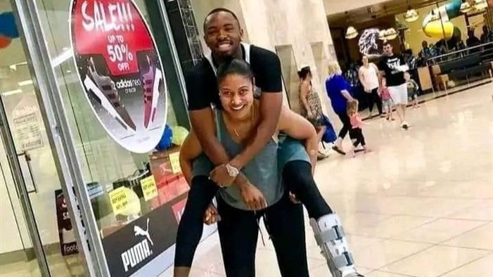TS Galaxy player Bernard Parker being carried by his wife Wendy on her back.