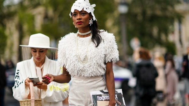 A guest wears a white lace hat during Paris Fashion Week - Womenswear Spring Summer 2020.  Photo by Edward Berthelot