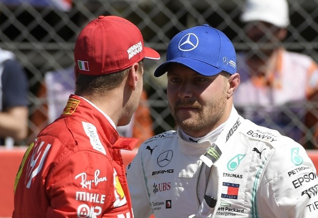Mercedes' Finnish driver Valtteri Bottas (R) speaks to Ferrari's German driver Sebastian Vettel after the qualifying session at the Circuit de Catalunya in Montmelo in the outskirts of Barcelona on May 11. LLUIS GENE / AFP