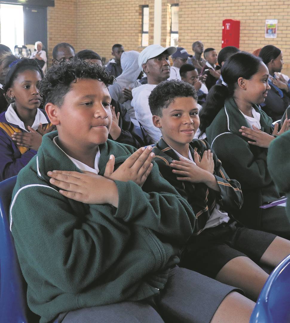 From left: Joel Kleinsmith, Tyler Thomas, and Trinity Robertson of De Kuilen Primary School, practise doing a “butterfly hug”, a relaxation technique that was demonstrated by mental health councillor Rene Botha.PHOTOS: Carina Roux