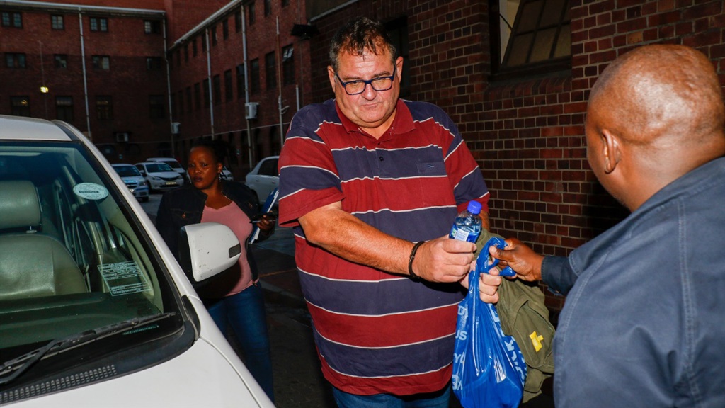 Willem Breytenbach arrives in handcuffs at the Cape Town Central police station. 