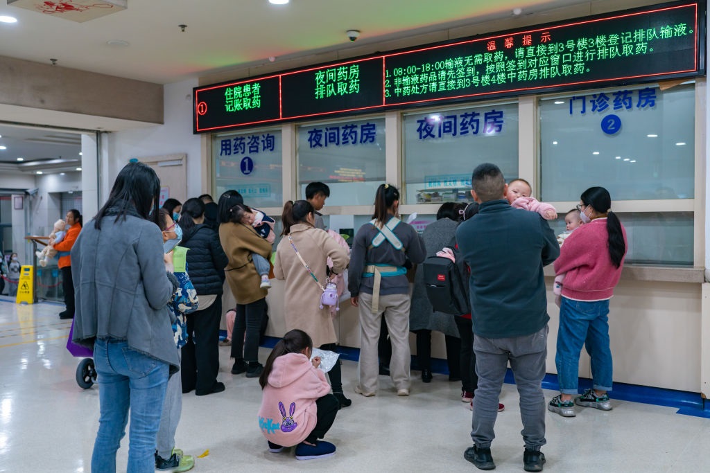 Parents with children who are suffering from respiratory diseases are lining up at a children's hospital in Chongqing, China, on 23 November 2023.