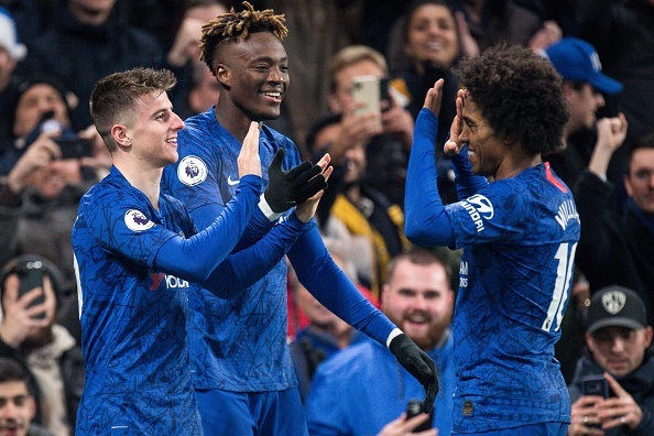 LONDON, ENGLAND - DECEMBER 04: Mason Mount of Chelsea FC celebrates with team mate Tammy Abraham and Willian after scoring goal during the Premier League match between Chelsea FC and Aston Villa at Stamford Bridge on December 4, 2019 in London, United Kingdom. (Photo by Sebastian Frej/MB Media/Getty Images)