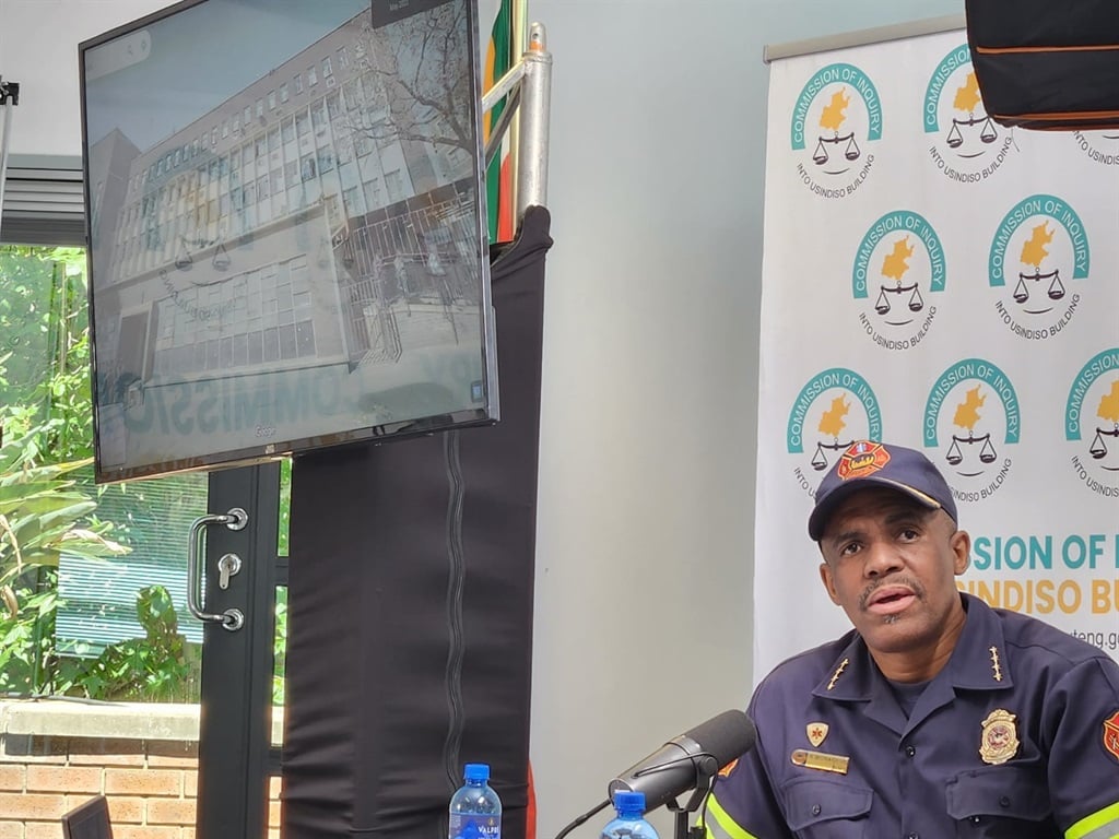 The acting Johannesburg chief of the Emergency Medical Services acting chief Rapulane Monageng takes the commission through images of the 80 Albert Avenue building before and after the fire. 