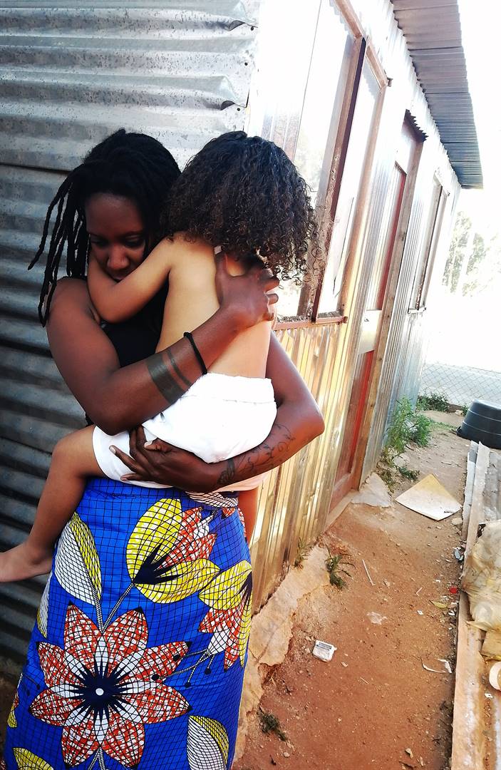 A black woman holds a biracial child. Picture: Masehume Motloenya/City Press