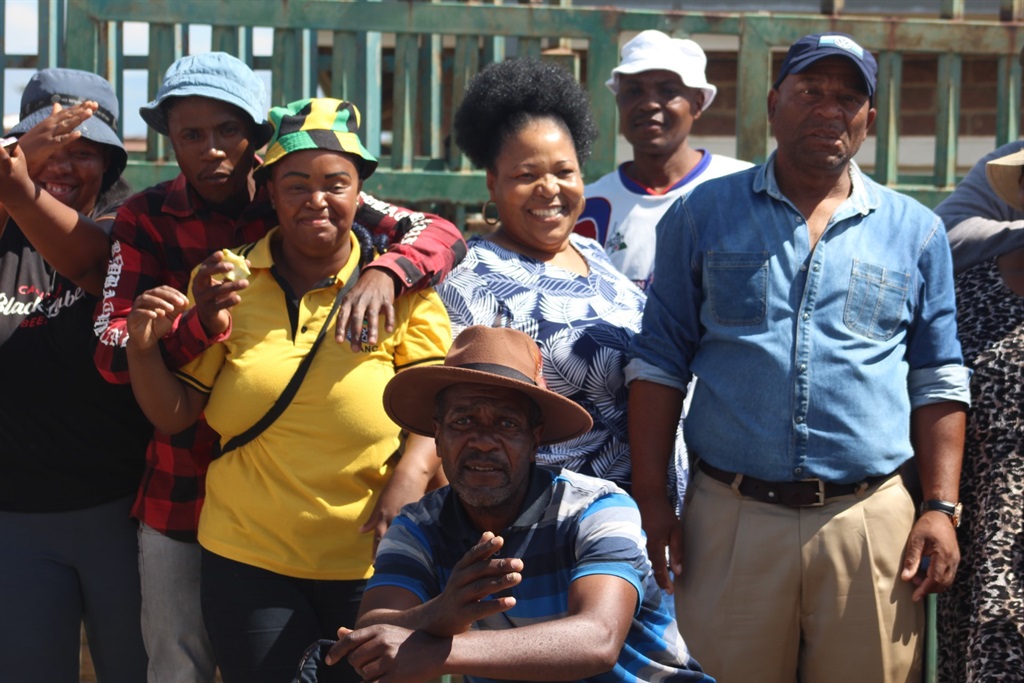 Matshidiso Morobe with yellow ANC t-shirt alongside community members during much anticipated court appearance of two security guards who allegedly slaughtered Sello Morobe.