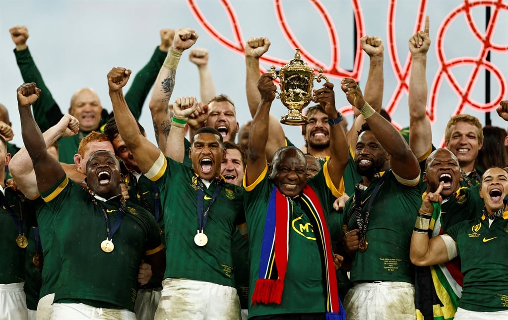 President Cyril Ramaphosa lifts the Webb Ellis Cup as South Africa celebrate winning the Rugby World Cup final. Photo by Reuters