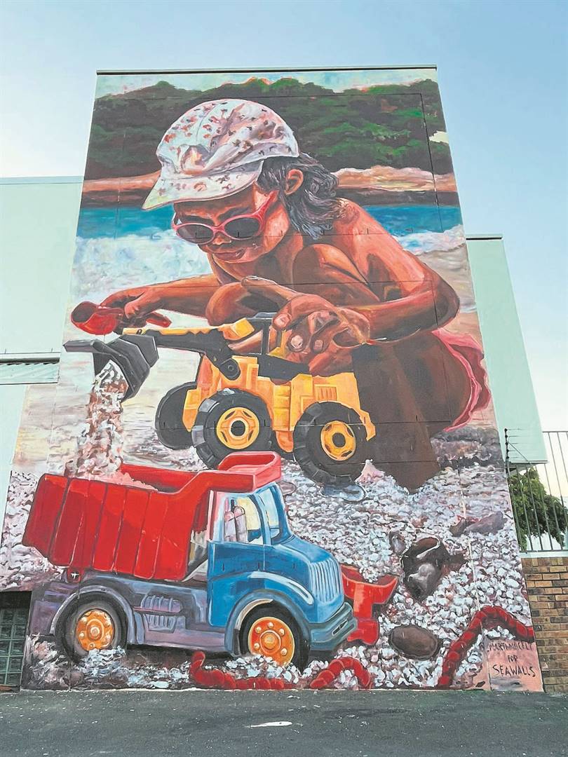 Marti Lund’s mural of a toddler digging up the beach with a toy truck and digger is a metaphor for unregulated mining up the Cape West Coast. PHOTO: Supplied