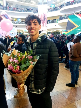 <p><em>Young Massimo here is waiting for his girlfriend, who's on the same flight as the Boks. He admits that Siya could get the flowers if she doesn't get to him first... (Simnikiwe Xabanisa/News24)</em></p>