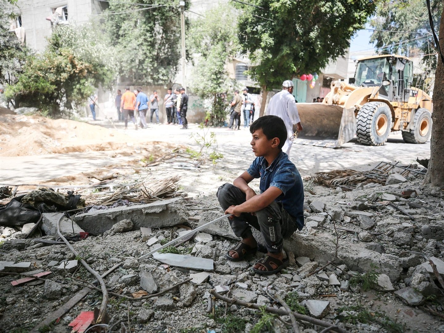 A boy looks on search and rescue works continued at debris of buildings after airstrikes by Israeli army hit buildings at Jabalia Refugee Camp in Gaza City, Gaza on May 17, 2021.
