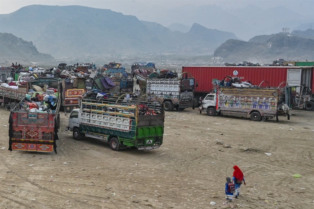 Afghan refugees arrive in a truck at a holding cen